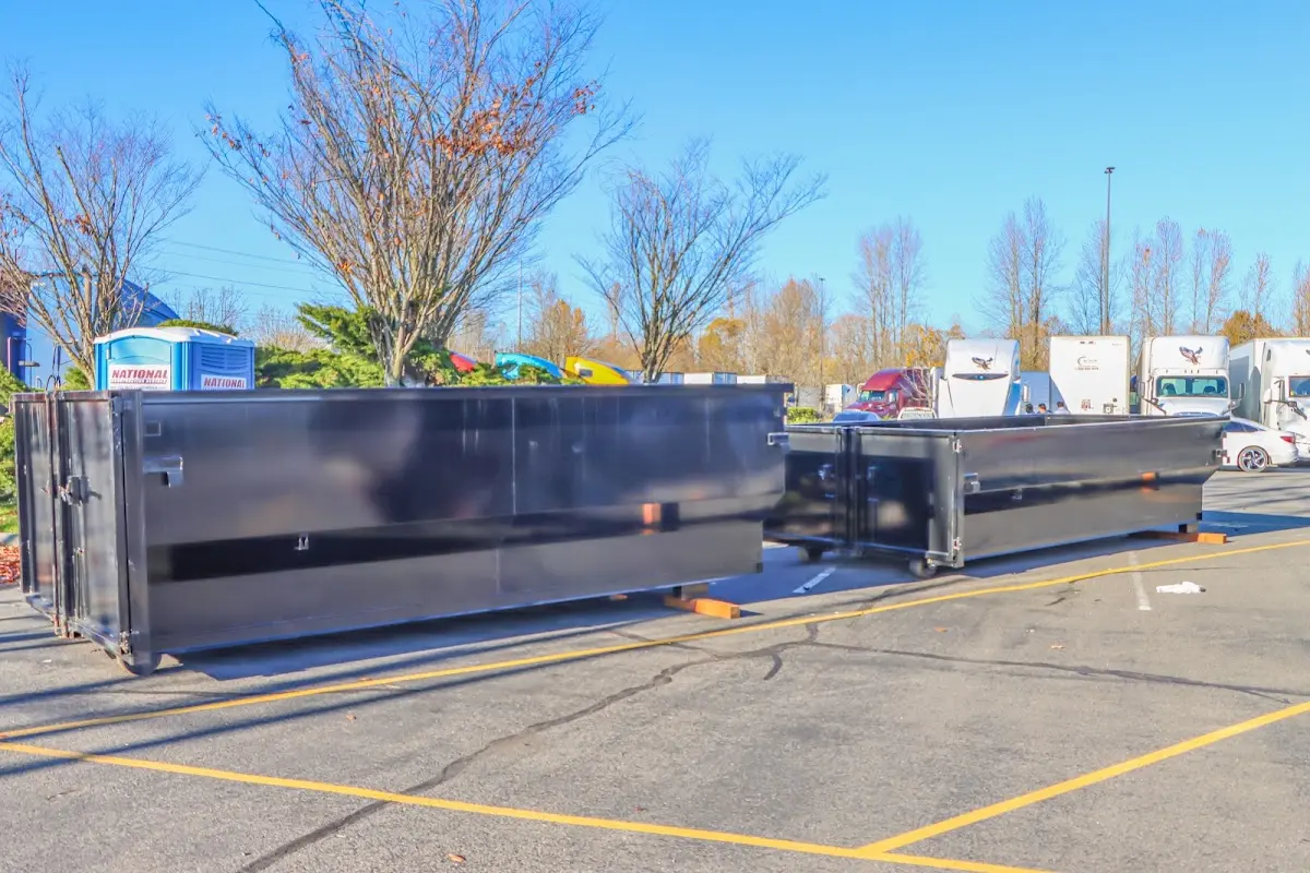 Professional dumpster rental service with roll-off container on residential driveway in Osceola